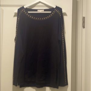 A black shirt with a metal bead detail